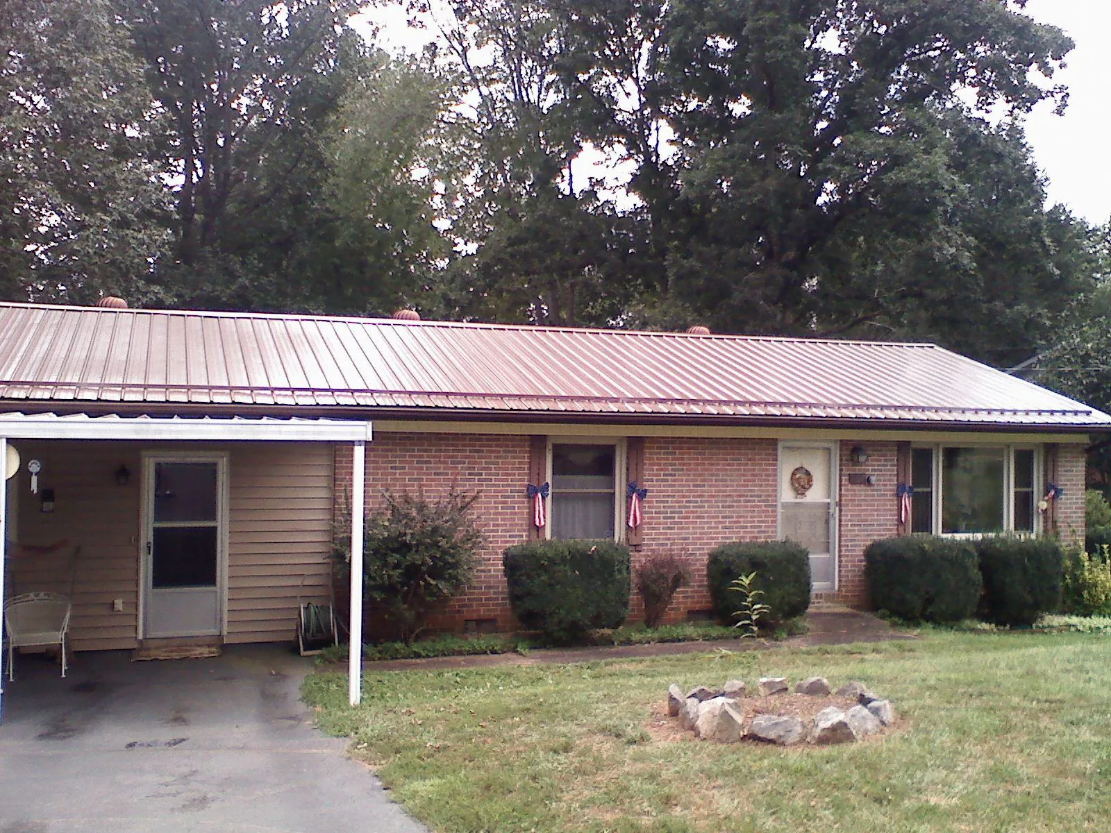 Bronze metal roof and carport on a brick ranch home — Roof Repair work by our crew in Rapidan